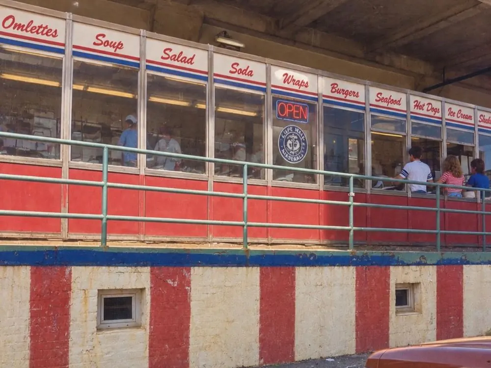 Red and white striped counter front with service windows under a covered overhang at 12 Channel Street