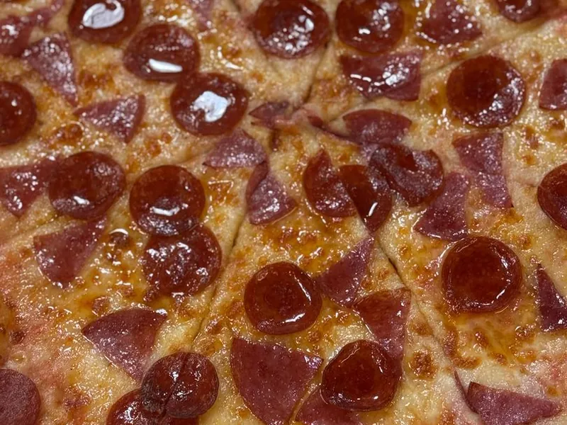 Pepperoni and salami pizza cut into slices